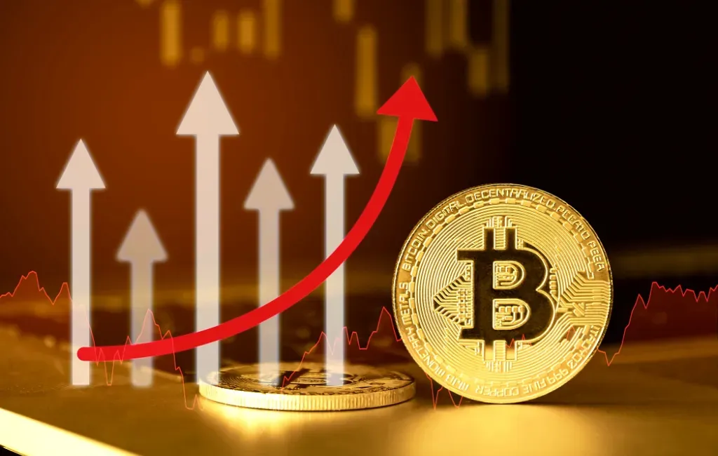 Bitcoin w postaci monety na tle wykresu zmiennego kursu krptowalut